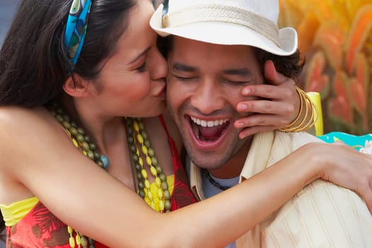 Close-up of a young woman kissing a young man