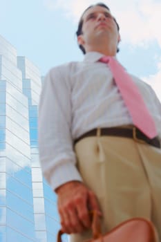 Low angle view of a businessman holding a handbag