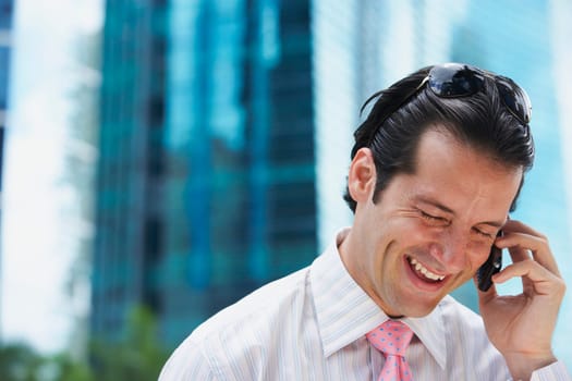 Close-up of a businessman talking on a mobile phone and smiling