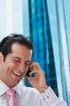 Close-up of a businessman talking on a mobile phone and smiling