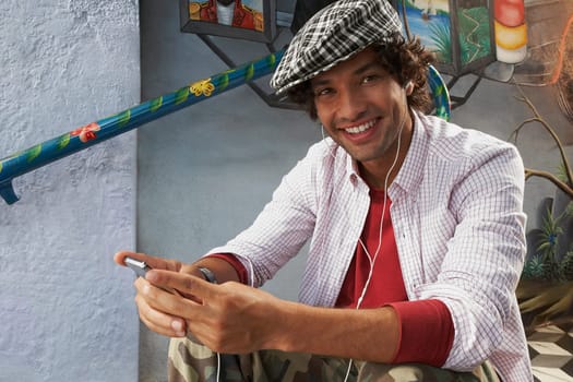 Portrait of a young man listening to music and smiling