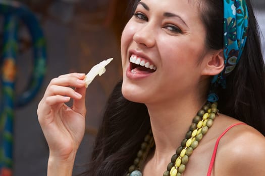 Close-up of a young woman eating potato chips