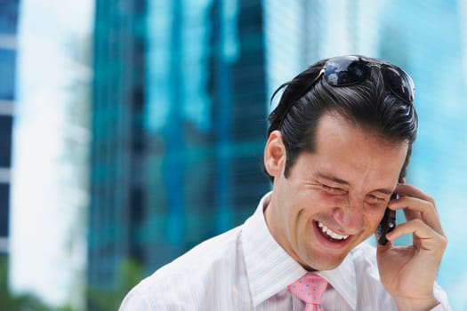 Close-up of a businessman talking on a mobile phone and smiling