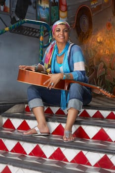 Portrait of a young woman holding a guitar