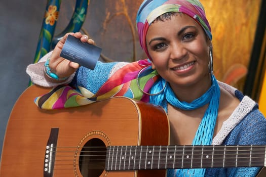 Portrait of a young woman showing a credit card
