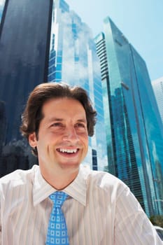 Businessman laughing in front of office buildings