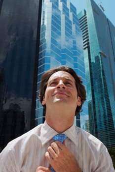 Close-up of a businessman adjusting his tie