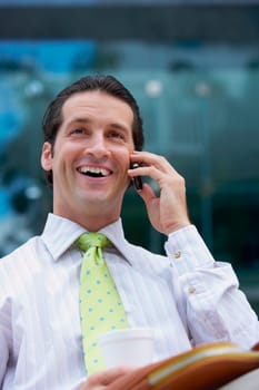 Businessman talking on a mobile phone and smiling