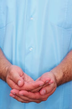 Mid section view of a male nurse cupping his hands
