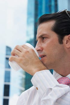 Close-up of a businessman drinking cold drink