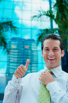 Portrait of a businessman making a thumbs up sign and smiling