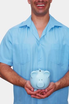 Mid section view of a male nurse holding a piggy bank and smiling
