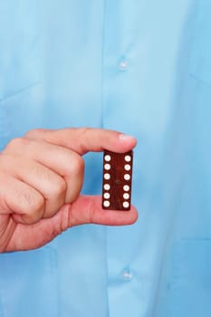 Mid section view of a male nurse holding two dices