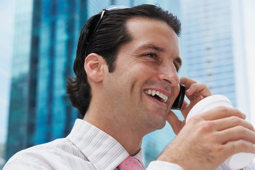 Close-up of a businessman talking on a mobile phone and smiling