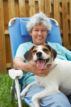 Portrait of a senior woman with a dog and smiling