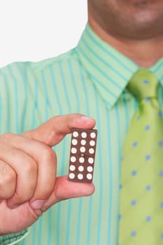 Mid section view of a businessman holding a domino