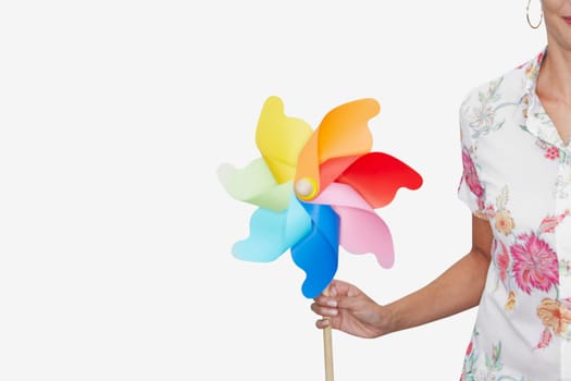 Mid section view of a woman holding a pinwheel