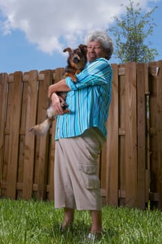 Portrait of a senior woman carrying a dog