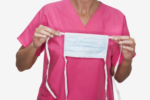 Mid section view of a female nurse holding a surgical mask