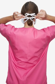 Rear view of a female doctor wearing a surgical mask