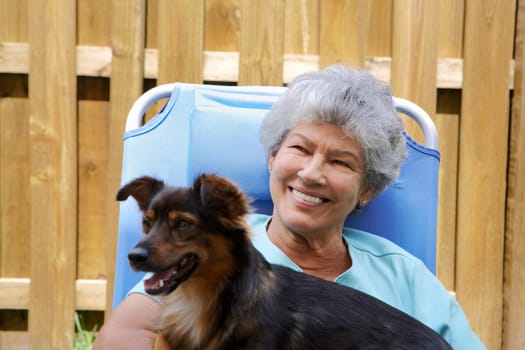 Close-up of a senior woman with a dog and smiling