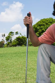 Man holding a golf club in a golf course