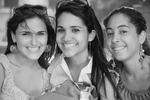 Portrait of three young women smiling