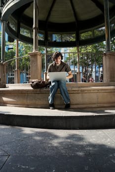Young man sitting and using a laptop