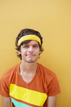 Portrait of a young man leaning against a wall