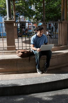 Young man sitting and using a laptop