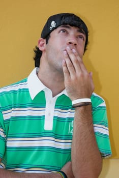 Close-up of a young man with his hands covering his mouth