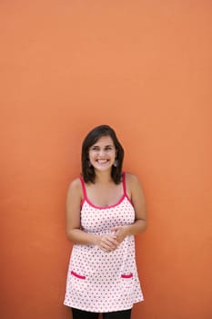 Young woman standing in front of a wall