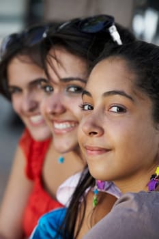 Portrait of three young women smiling
