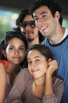 Close-up of two young women smiling with two young men