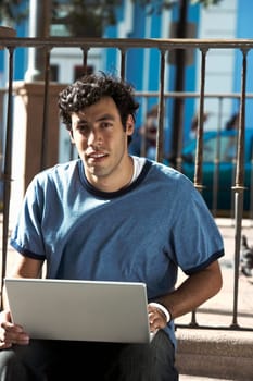 Portrait of a young man using a laptop