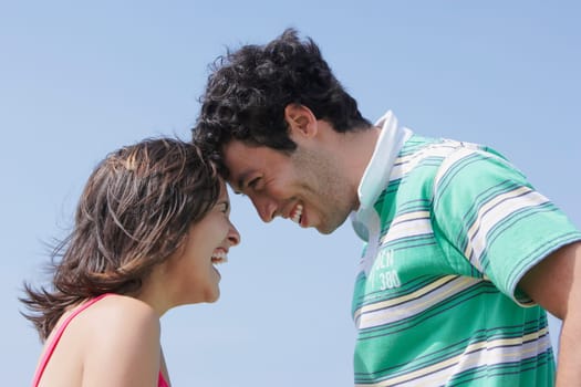 Side profile of a young couple looking at each other and smiling