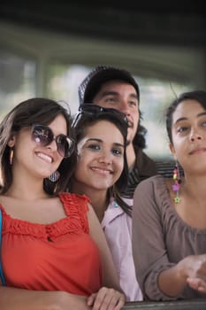 Close-up of three young women standing with a young man