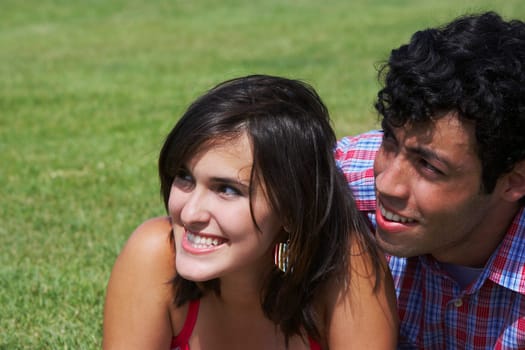 Close-up of a young couple smiling and looking away
