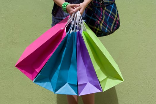 Mid section view of a woman holding shopping bags