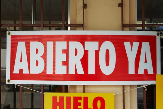 Close-up of an Open sign hanging from a store window