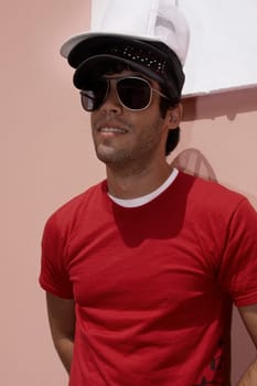 Close-up of a young man wearing three caps