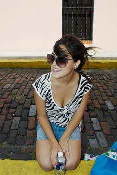 Close-up of a young woman wearing sunglasses and smiling
