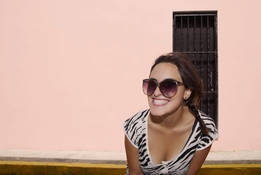 Close-up of a young woman wearing sunglasses and smiling