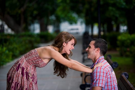 Side profile of a young couple looking at each other and smiling