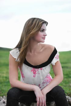 Young woman sitting in a field