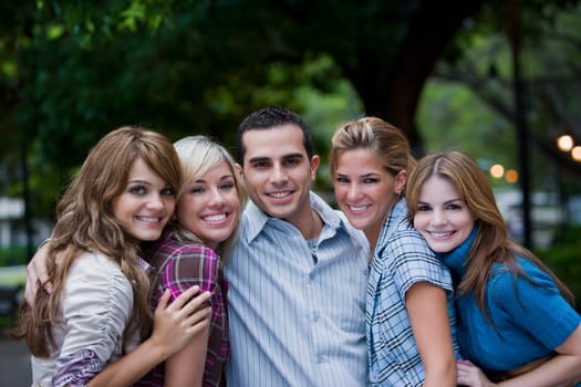 Portrait of a young man smiling with four young women