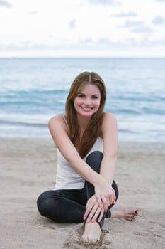 Portrait of a young woman sitting on the beach