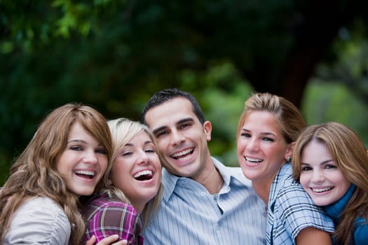 Portrait of a young man smiling with four young women