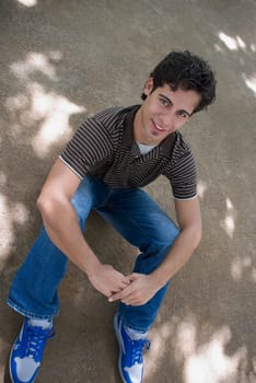 Portrait of a young man sitting with his hand on his knee