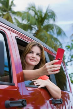 Young woman taking a picture with a mobile phone and looking away